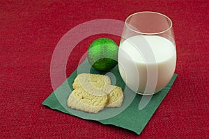 Molasses cookies and glass of milk and Christmas ornament