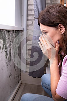 Mold Damage On House Wall. Woman Looking photo