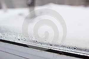 mold on a foggy plastic window of white color.