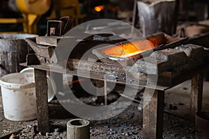 Mold with molten metal in the foundry workshop of metallurgical plant