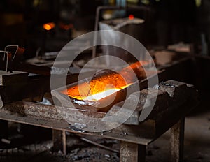 Mold with molten metal in the foundry workshop of metallurgical plant