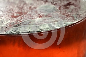Mold on red liquid background, fungus background, bacteria on red surface, Mold growth on red surface