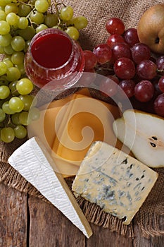 Molded cheese, wine and fruit vertical top view closeup