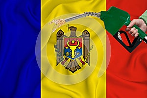 MOLDOVA flag Close-up shot on waving background texture with Fuel pump nozzle in hand. The concept of design solutions. 3d