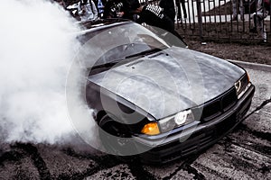 Moldova 25.09.2019. Sport modern Stance E36 BMW Car racing car drifting with smoke drift burnout, Blue clouds with