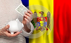 Moldovan woman with money bank on the background of Moldova flag. Dotations, pension fund, poverty, wealth, retirement concept