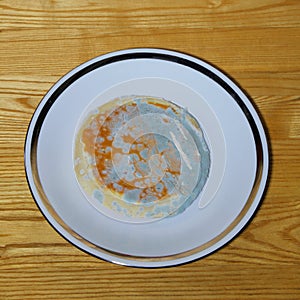 Moldy bread on the white plate