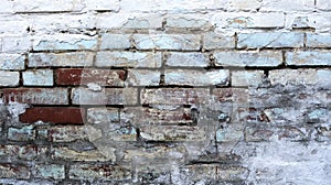 Moldy painted white old brick wall