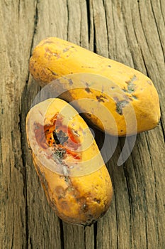 Moldy papaya fruit on wood background