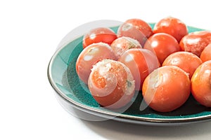 Moldy tomatoes on a plate closeup