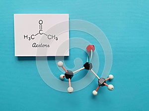 Molecular structure model and chemical formula of acetone, the simplest ketone, an organic solvent used in nail polish remover photo