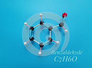 Benzaldehyde, aromatic aldehyde. Molecular structure model and chemical formula of benzaldehyde