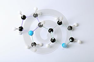 Molecule of nicotine on white background, top view. Chemical model