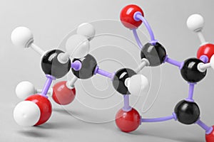 Molecule of vitamin C on light grey, closeup. Chemical model