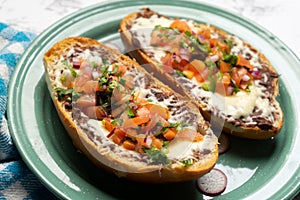 Molletes with fresh sauce and cheese. Mexican food photo