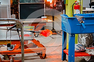 Molten glass being made into an ornament