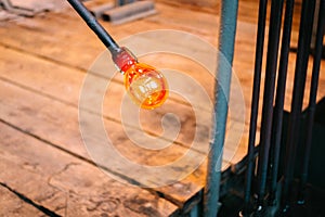 Molten glass is blown at the end of the pipe