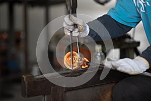 Molten glass on a metal rod