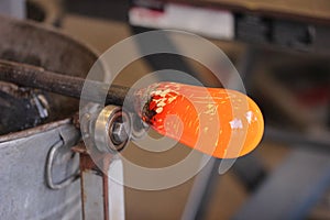 Molten glass on a metal rod for glass blowing macro