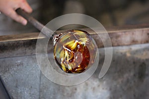 Molten glass on a metal rod for glass blowing macro