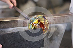 Molten glass on a metal rod for glass blowing macro