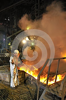 Molten hot steel pouring and worker