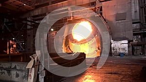 Molten iron in coreless furnace at the metallurgical plant. Stock footage. Big vat full of molten steel, heavy industry