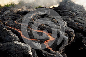 Molten Lava Flowing onto Solidified Lava Field