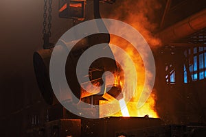Molten metal casting. Pouring iron with smoke and sparks. Metallurgical plant. Steel production. Foundry blast furnace