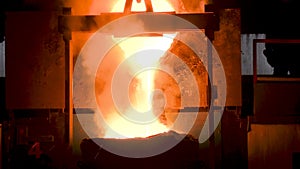 Molten metal pouring out of furnace. Liquid metal from blast furnace