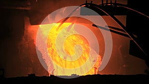 Molten metal pouring out of furnace. Liquid metal from blast furnace