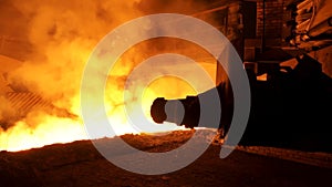 Molten steel flowing in ladle with many sparcles and steam, heavy industry concept. Modern steel plant and molten metal