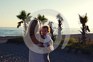 Mom with baby on the beach in side, Turkey