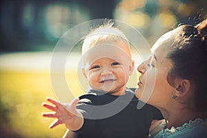 Mom and baby boy outdoor. Mother hug little son with love. Woman with child. Mothers day concept. Happy family enjoy