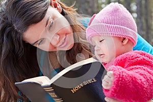 Mom And Baby Daughter Reading Bible