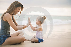 Mom and baby playing near beach. Traveling with family, child