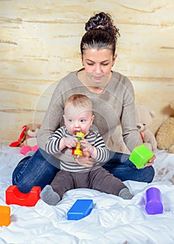 Mom and Baby Playing Plastic Blocks at Home