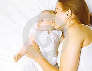 Mom and baby sleeping in bed, Infancy, motherhood and harmony