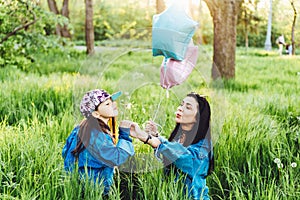 Mom andbeautiful girl on the lawn