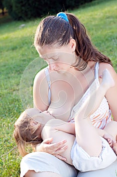 Mom breast feeding girl