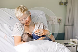 Mom breastfeeding her newborn baby boy in a hospital