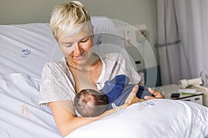 Mom breastfeeding her newborn baby boy in a hospital