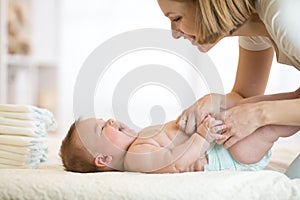 Mother changing a diaper on newborn baby