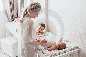 Mom changing diaper to baby