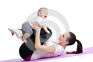 Mom with child do gymnastic and fitness exercises