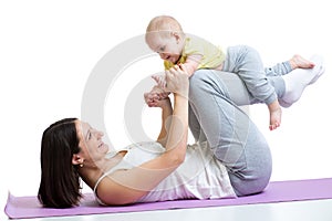 Mom with child do gymnastic and fitness exercises