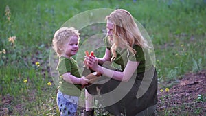 Mom and child in the forest eating bread