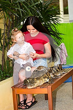 Mom and child girl on Crocodile farm in Phuket