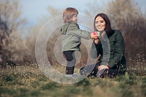 Mom and Child Playing with Teacups Outdoors