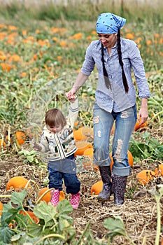 Mom and Child Walking in a Pumpkin Patch